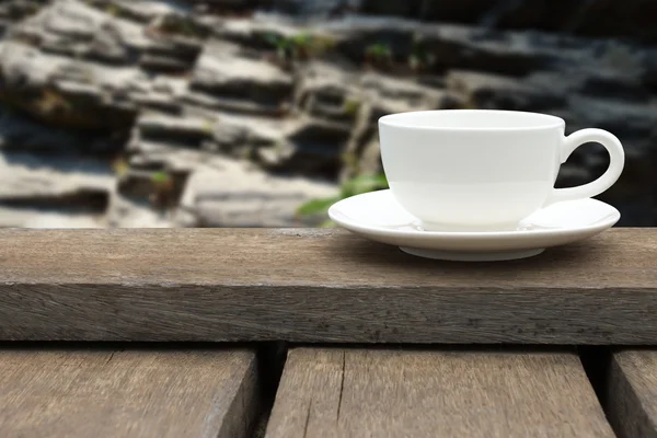 White coffee cup on wood floor. — Stock Photo, Image