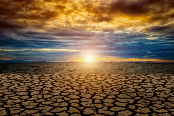 Cracked ground from Global warming with sunset and color cloud. — Stock Photo, Image