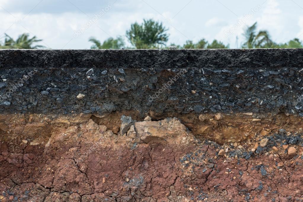 The layer of asphalt with soil and rock.