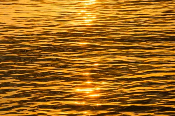 Emas reflektif permukaan air matahari terbenam di danau . — Stok Foto
