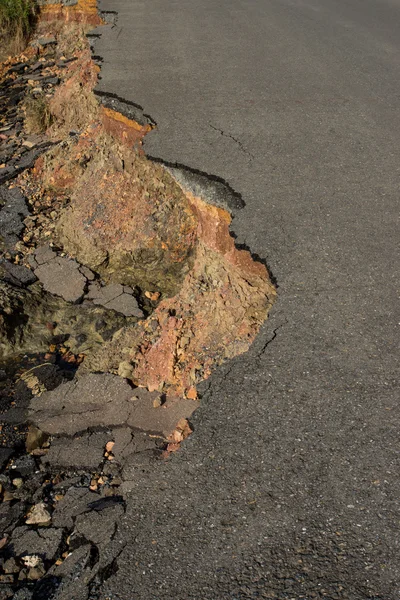 Боковая сторона разбитых асфальтовых дорог рухнула и упала — стоковое фото
