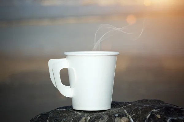 Paper coffee cup on the beach — Stock Photo, Image