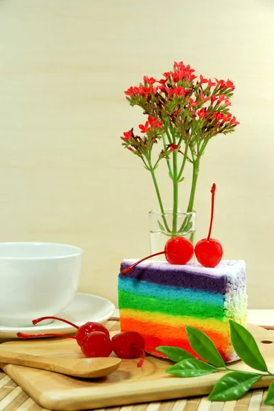 Rainbow cake with cherries — Stock Photo, Image
