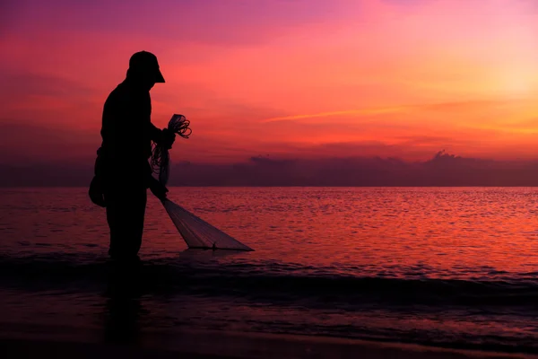 Silhouettes fisherman casting at the sea. — Stock Photo, Image