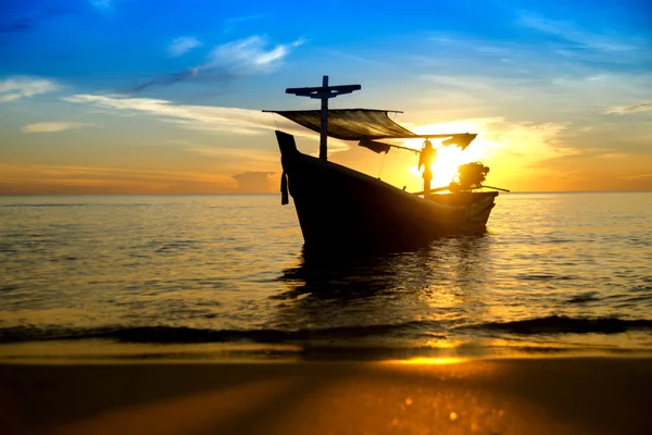 Silhouettes of Fishing boat on the beach. Stock Picture