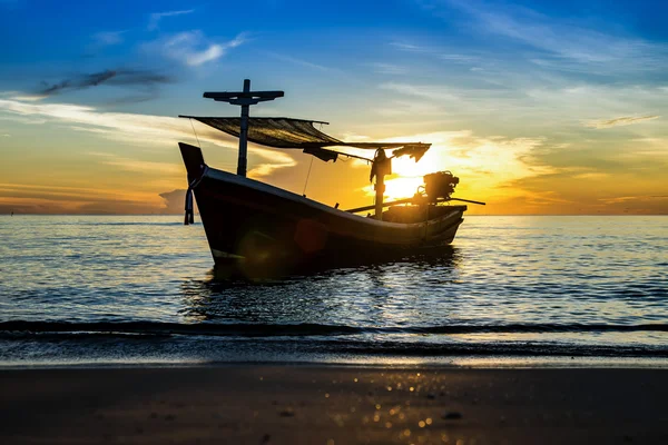 Silhouettes of Fishing boat on the beach. Royalty Free Stock Images