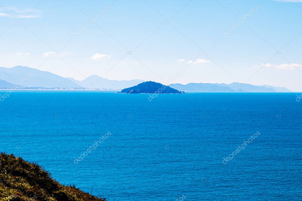 High view of Campeche Island in Florianopolis Brazil from the trail from Matadeiro to Lagoinha do Leste at Florianpolis, Brazil. A beautiful blue tone sea.