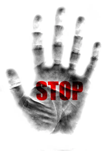 Outline of hand print on white background showing palm with stop written across it in red