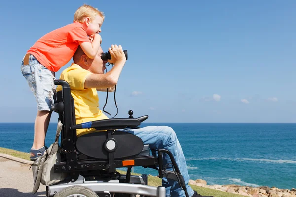 Disabled father and son play with Binocular — Stock Photo, Image