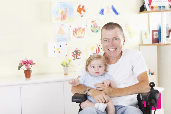 Disabled man with baby boy — Stock Photo, Image