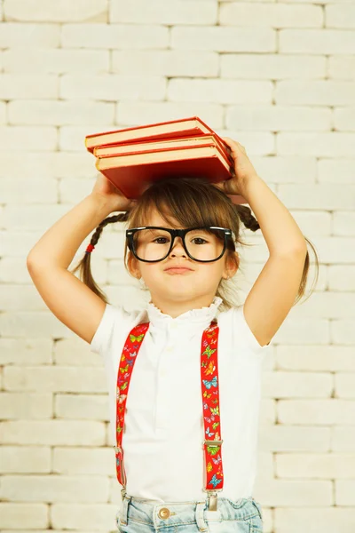 Preschooler girl with books — Stock Photo, Image