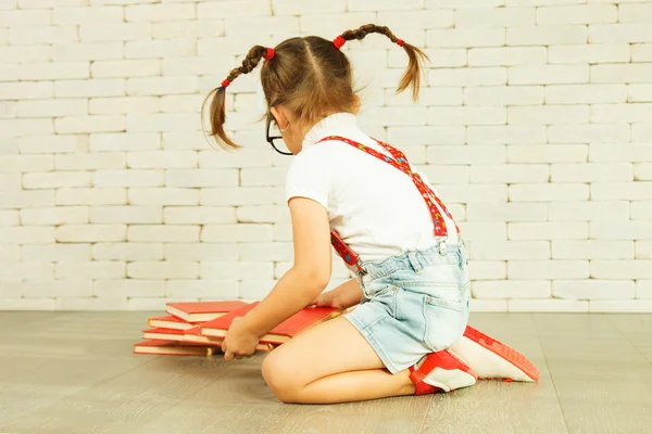 Preschooler girl with books — Stock Photo, Image