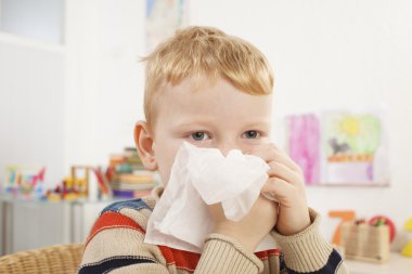 Preschooler blows her nose