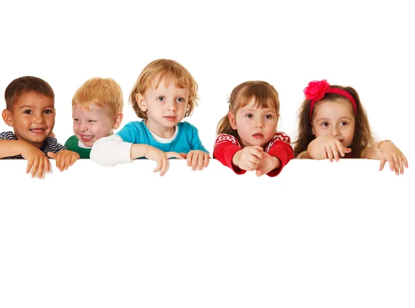 Multi ethnic children holding a blank placard — Stock Photo, Image