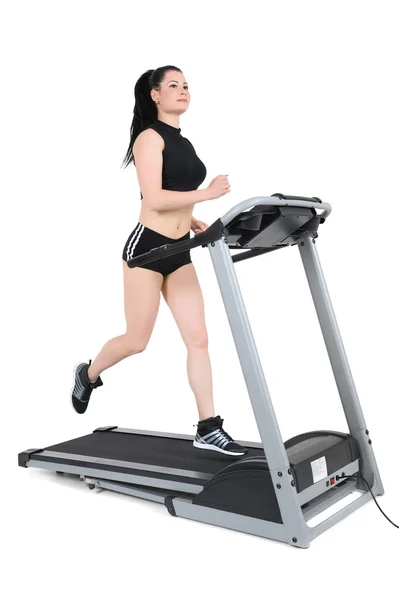 Young woman running on treadmill — Stock Photo, Image