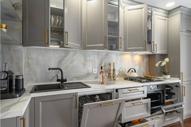 Gri ve beyaz modern klasik mutfağın tüm kapıları açık.