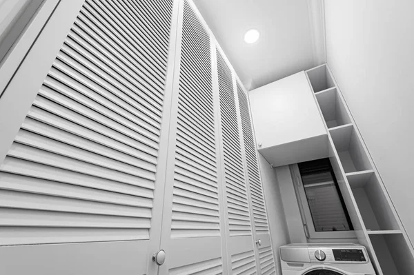 Lavanderia branca dentro da sala wardobe em novo apartamento — Fotografia de Stock