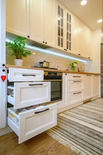 Cozy modern kitchen interior, some drawers pulled out