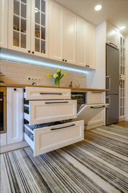 Sıcak, modern mutfak iç mekanı, bazı çekmeceler çıkarılmış.