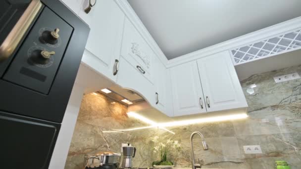 Closeup tilt camera movement at modern classic white kitchen interior — Stock Video