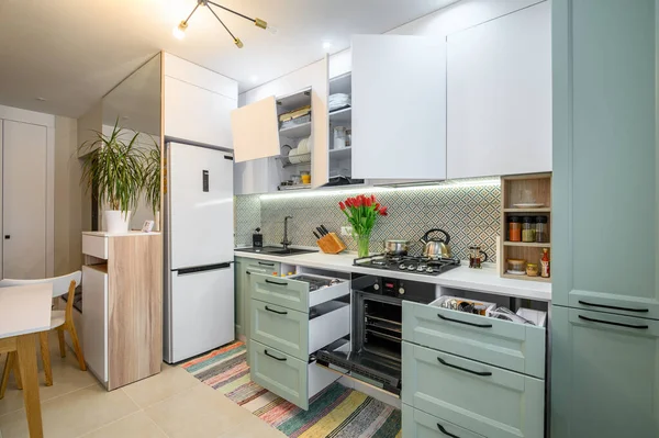 Cozy modern kitchen interior, some drawers pulled out