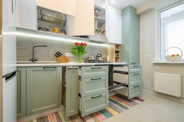 Cozy modern kitchen interior, some drawers pulled out