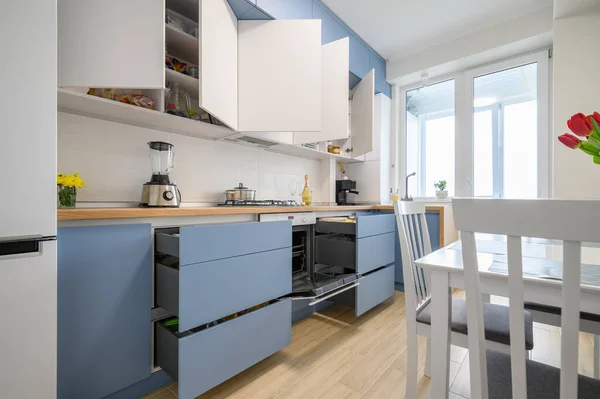 Cozy modern kitchen interior, some drawers pulled out