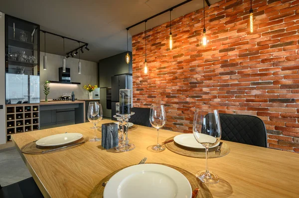 Modern luxurious dark gray and black kitchen with dining table — Stock Photo, Image