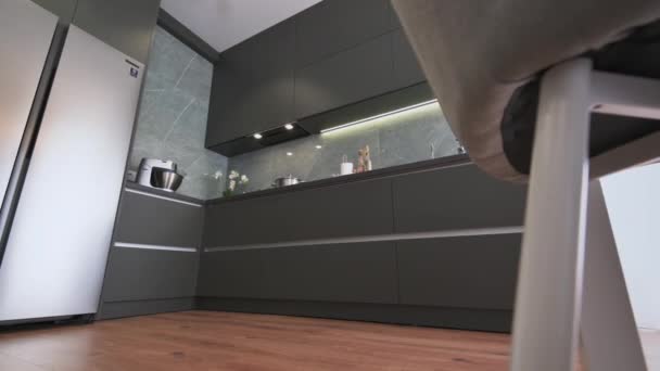 Modern luxury dark gray kitchen shot from low angle — Stock Video