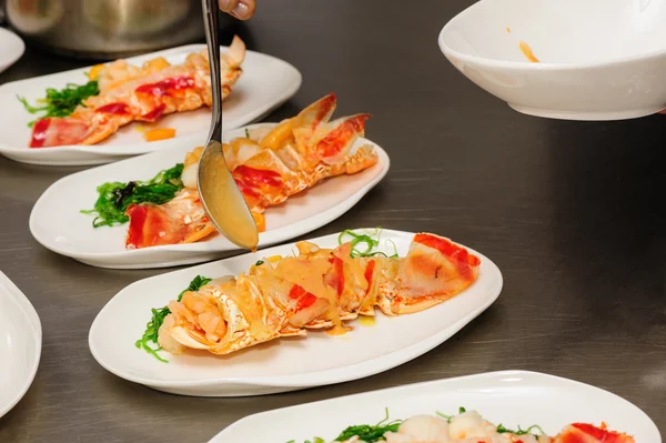 Decorating cooked lobster on plate — Stock Photo, Image