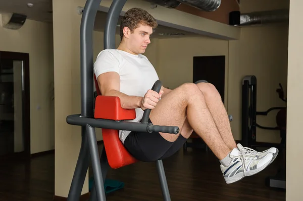 Young man doing lats pull-down workout — Stock Photo, Image