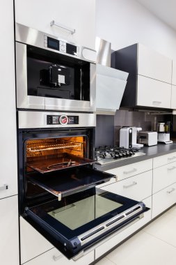 Modern custom hi-tek kitchen, oven with open door clipart