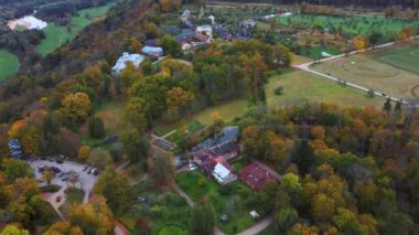 Sigulda ve Turaida, Letonya yakınlarındaki Gauja Ulusal Parkı 'ndaki Krimulda Sarayı' nın hava görüntüsü. Sonbaharda Bahçeli Eski Malikane. Gauja Nehri 'nin Eski Vadisi, Krimulda, Krimulda Malikânesi, Turaida Şatosu' nun olduğu Dağ 'daki Renkli Orman. 4K Video