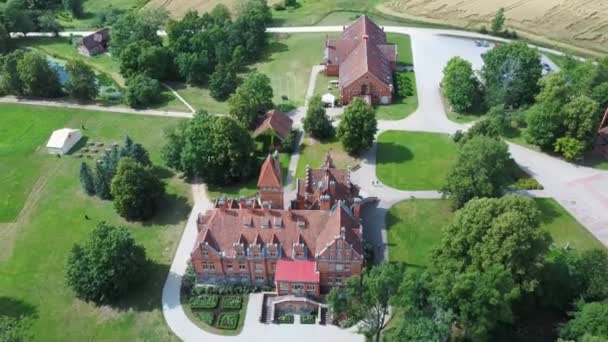 位于拉脱维亚图库姆附近的Jaunmoku Brick中世纪城堡 位于阳光明媚的夏日明媚的湖畔 在Jaunmokas庄园公园 Aerial Dron Sshot — 图库视频影像