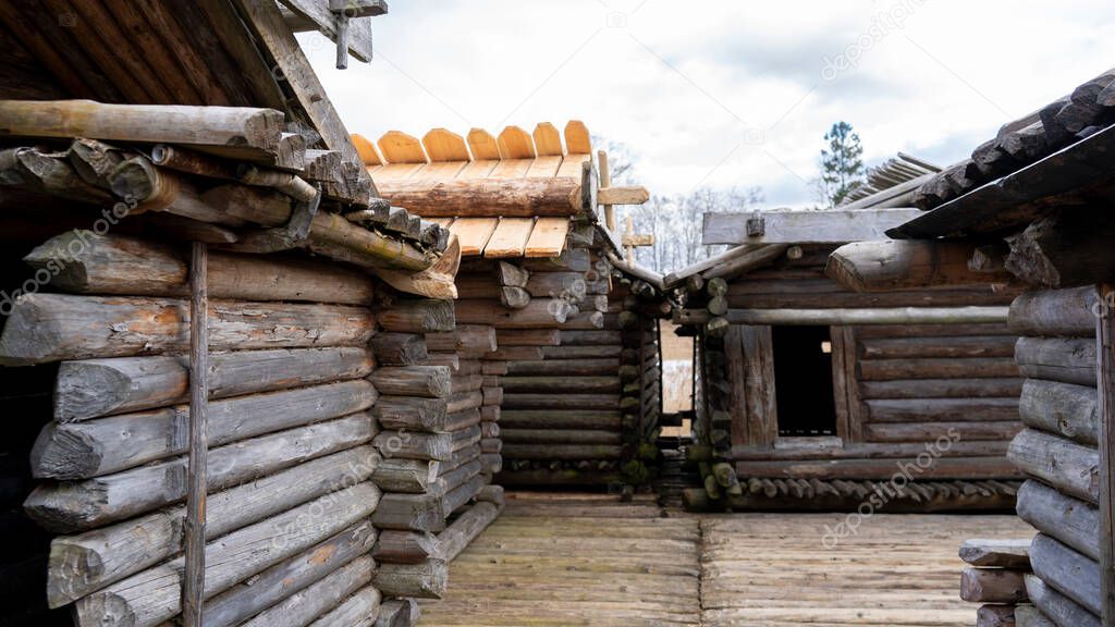 Araisi Lake Castle in Latvia. Historical Wooden Buildings on Small lake Island in the Frozen Lake Araisi in the Winter. Reconstruction of Wooden Fortified Settlement of Ancient European People