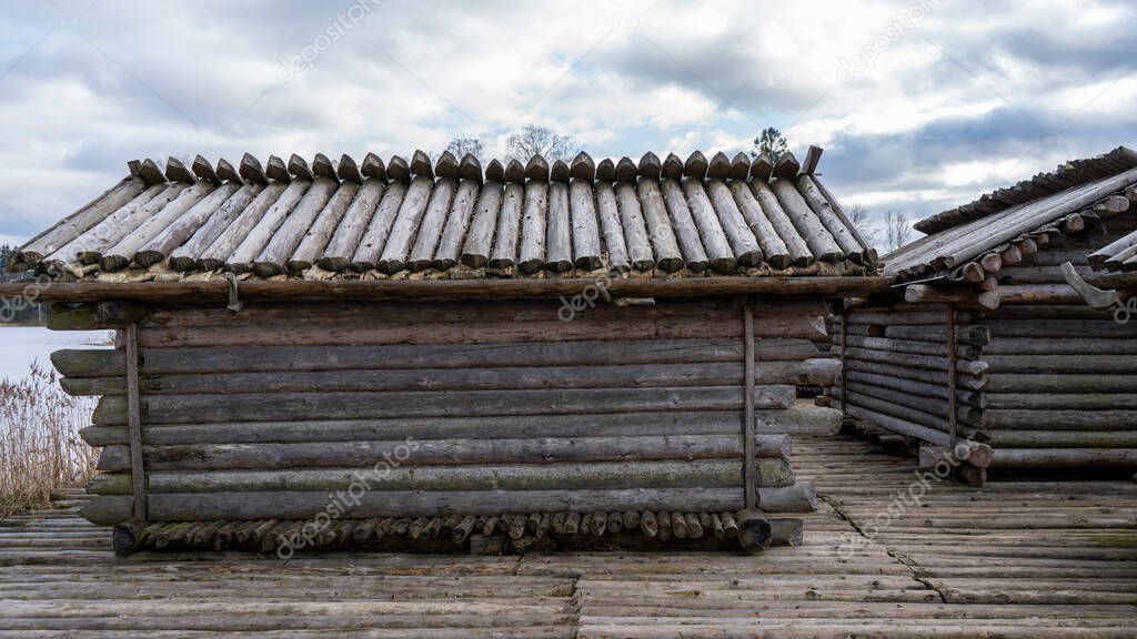 Araisi Lake Castle in Latvia. Historical Wooden Buildings on Small lake Island in the Frozen Lake Araisi in the Winter. Reconstruction of Wooden Fortified Settlement of Ancient European People