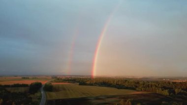 Çifte Gökkuşağı Orman ve Buğday Tarlası. Kara Gök Gürültülü Bulutlar ve Kırsal Otoyol Üzerinde Gökkuşağı. Areal Dron Şut.