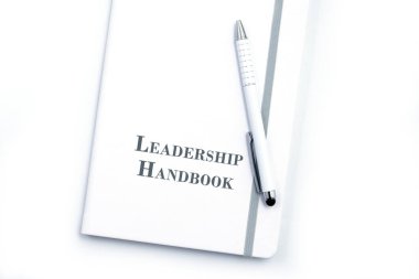 White Leadership Handbook or manual with White pen on white table surface - personnel management policy, explains business goals, results, defines Leadership practices clipart