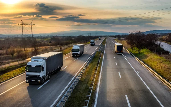 Highway Transit Convoy Caravan Transportation Trucks Passing Highway Amazing Sunset — Stock Photo, Image