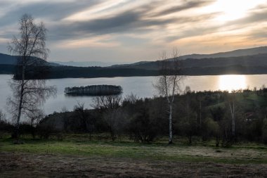 Gölün üzerinde büyüleyici bir günbatımı ve suyun üzerinde güzel bir yansıması var. Mavi saatte dingin göl. Doğa manzarası