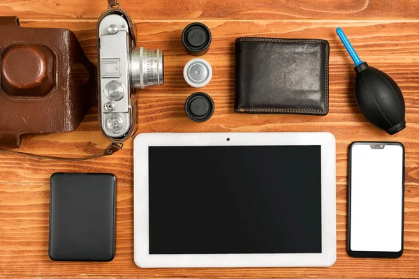 Journalistic equipment - tablet, phone, camera, lenses, album, wallet and different objects. Vintage and modern concept. Freelancers outfit. Clipping mask for screen