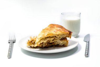 Yoğurt ve ustenil ile servis edilen Burek Geleneksel Etli Turta. Geleneksel Balkan kahvaltısı. Beyaz arkaplanda izole