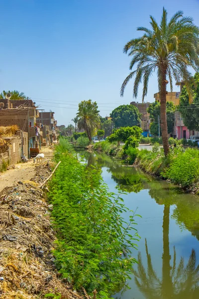 Poor buildings on the Nile canal near Qena, Egypt