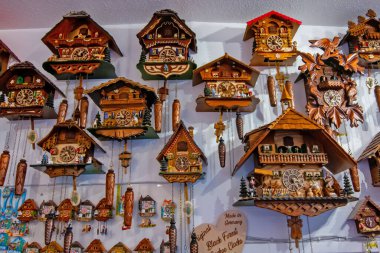 Colmar 'da geleneksel el yapımı ahşap guguklu saatlerin yoğun duvar görüntüsü.