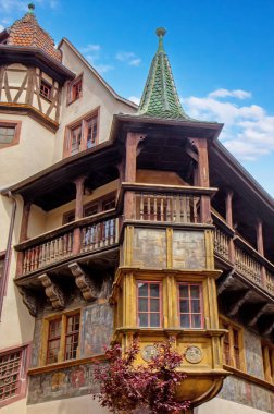 Ünlü Rönesans Maison Pfister 'ı, Colmar caddesinin tarihi köşesine hükmeden boyalı cephe ve ahşap balkonu..