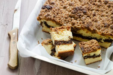 Close-up view of coffee cake has a ribbon of coffee filling and a crisp streusel topping. 