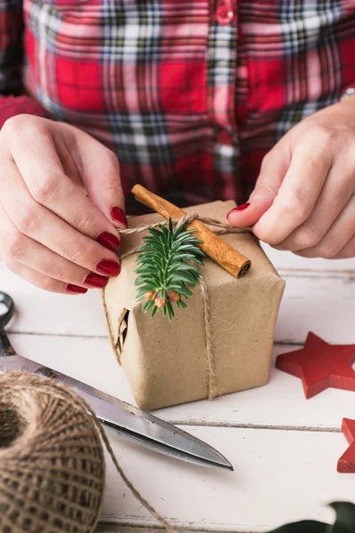 Woman wrapping natural christmas gift Stock Photo