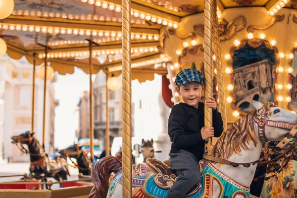 Littel boy on carousel ride — Stock Photo, Image