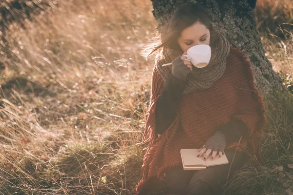 Drinking tea or coffee and writing notes Stock Image