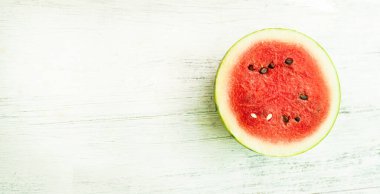 Slice of ripe watermelon on white wood table, summer concept.
